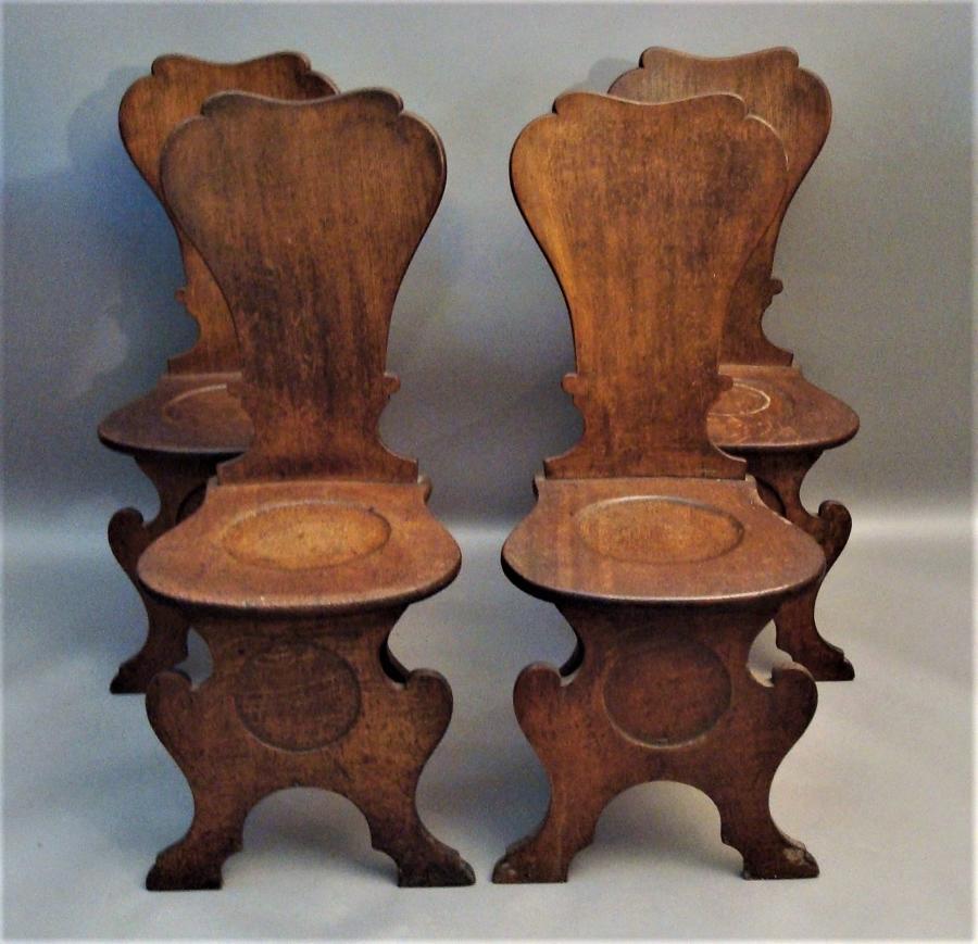 George II set of four oak scabello hall chairs