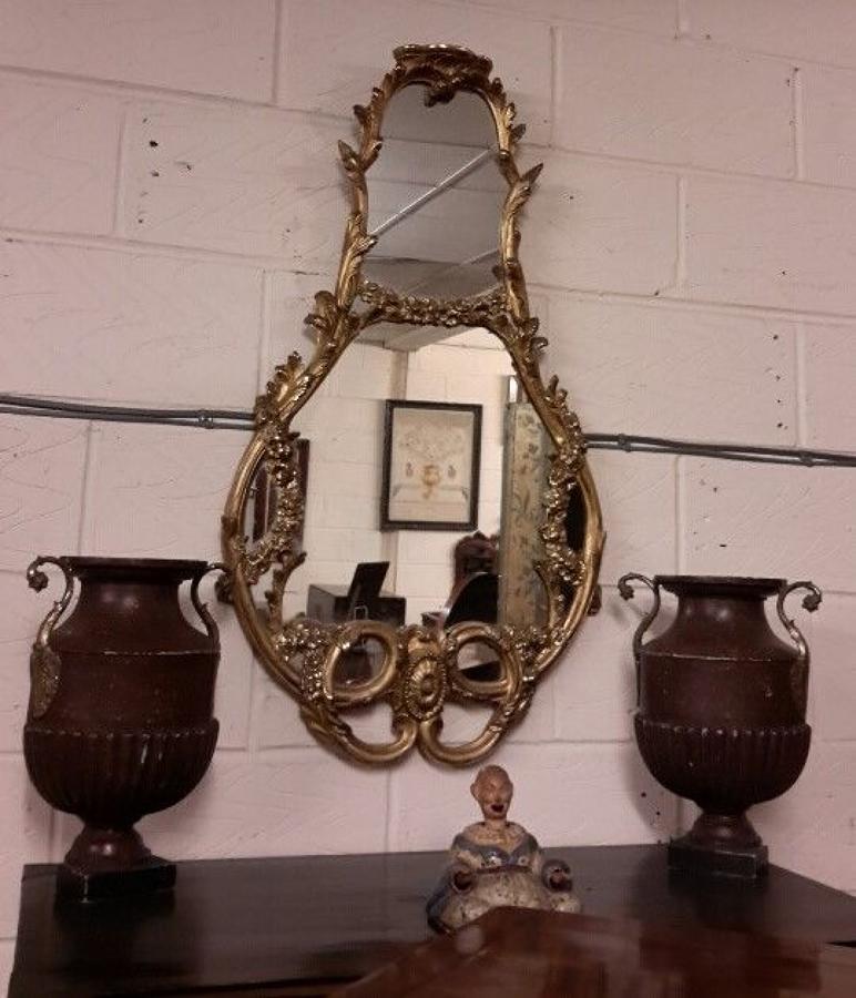 C19th shaped giltwood and gesso wall mirror