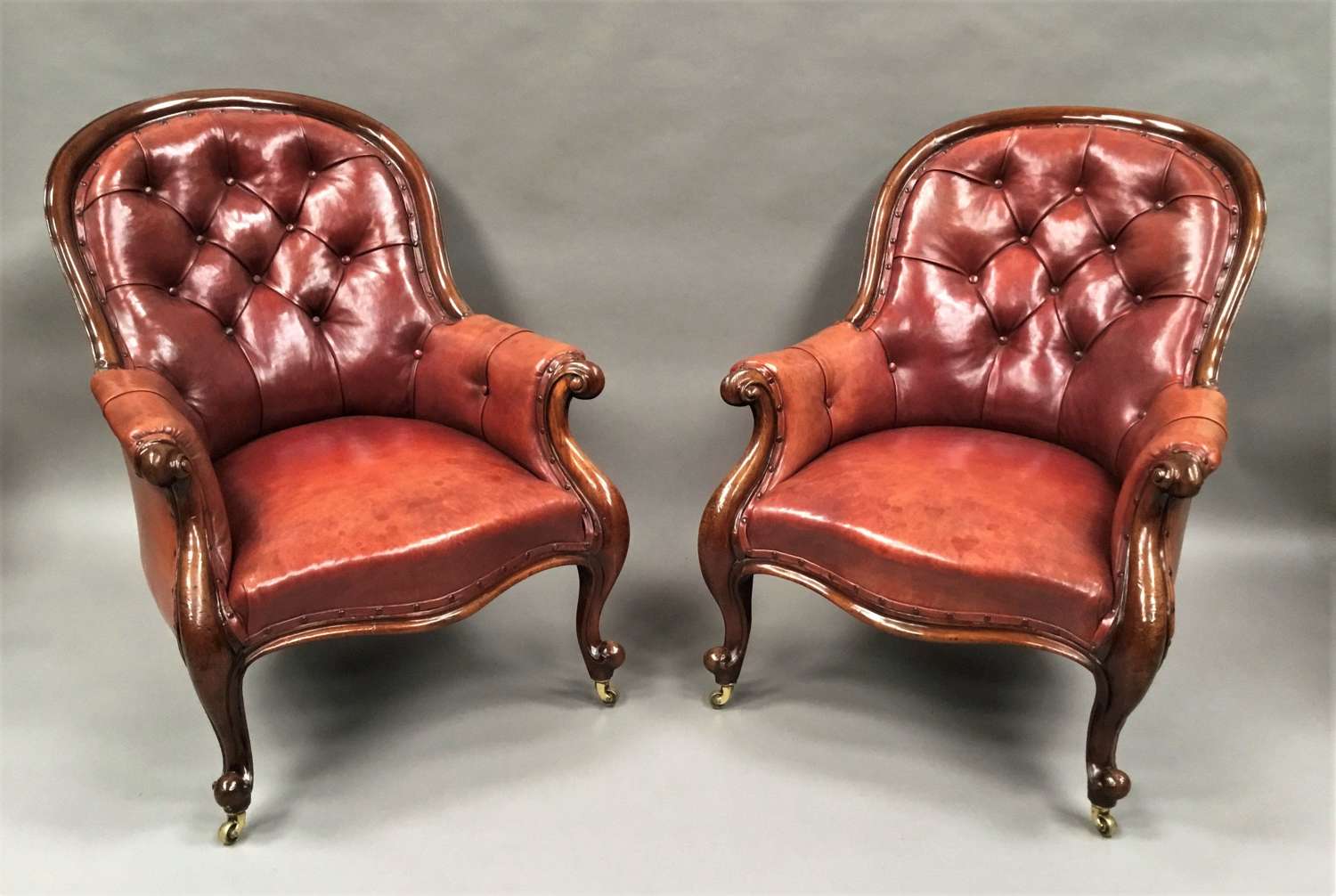 Mid C19th pair of mahogany and leather library armchairs