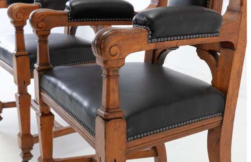 An unusual C19th pair of golden oak and leather open armchairs