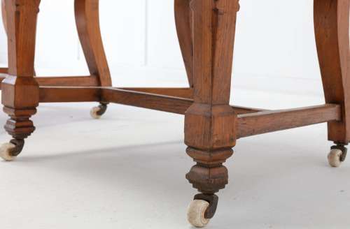 An unusual C19th pair of golden oak and leather open armchairs