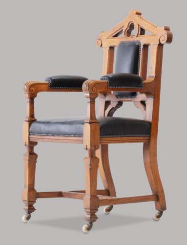 An unusual C19th pair of golden oak and leather open armchairs
