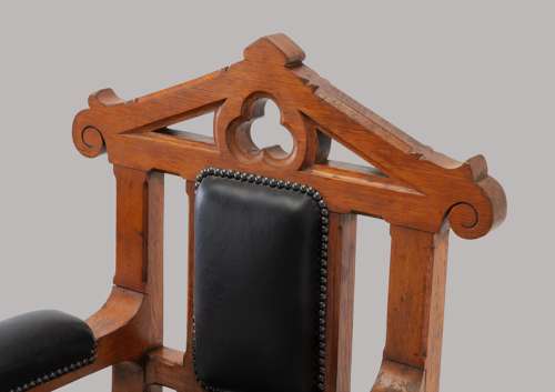 An unusual C19th pair of golden oak and leather open armchairs