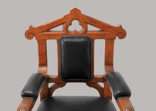 An unusual C19th pair of golden oak and leather open armchairs