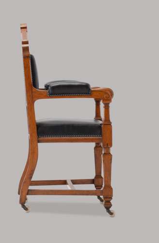 An unusual C19th pair of golden oak and leather open armchairs