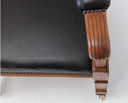 An unusual C19th pair of golden oak and leather open armchairs
