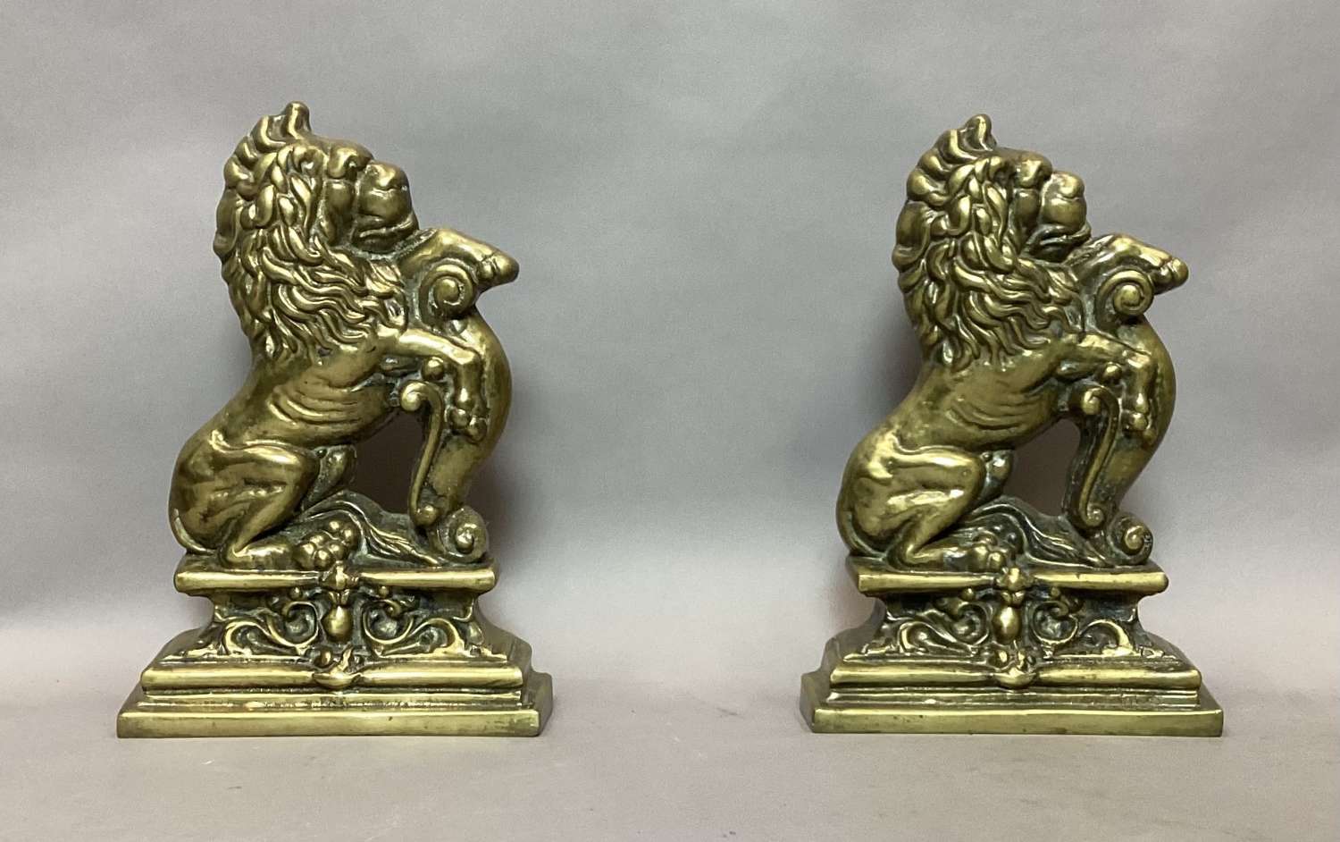 Rare C19th pair of brass lion doorstops / door porters