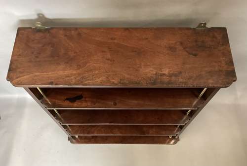 Good Regency mahogany and brass hanging wall shelves