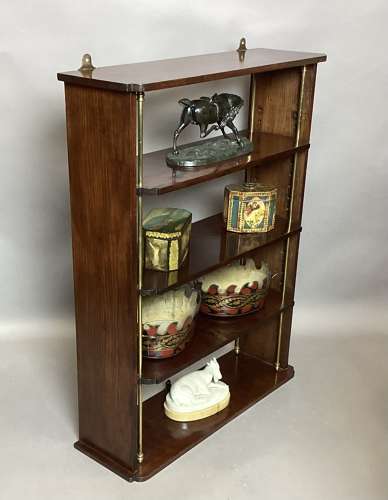 Good Regency mahogany and brass hanging wall shelves