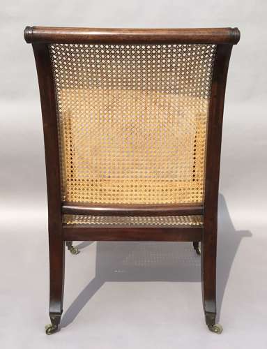 A splendid Regency mahogany bergere library chair