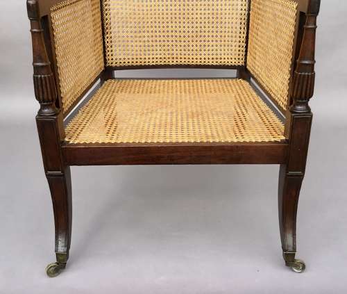 A splendid Regency mahogany bergere library chair