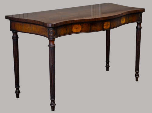 An exceptional George III mahogany serpentine side / serving table