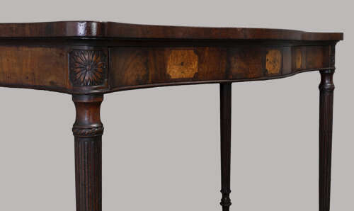 An exceptional George III mahogany serpentine side / serving table